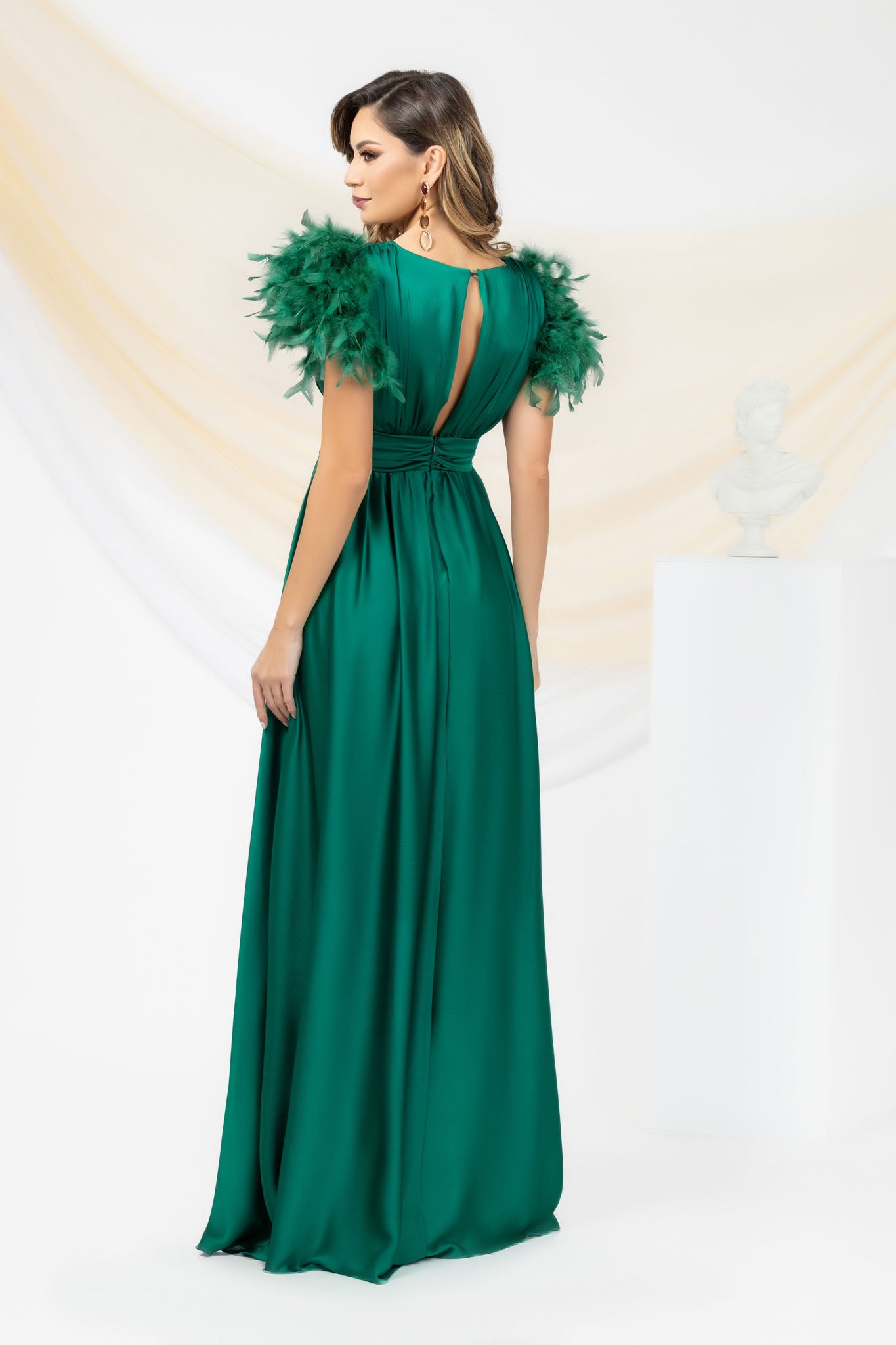 Green Long Occasional Dress With Sleeves Elegantly Accessorized With Feathers