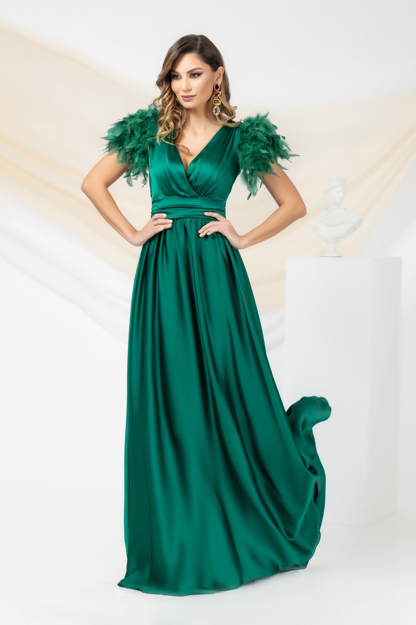 Green Long Occasional Dress With Sleeves Elegantly Accessorized With Feathers