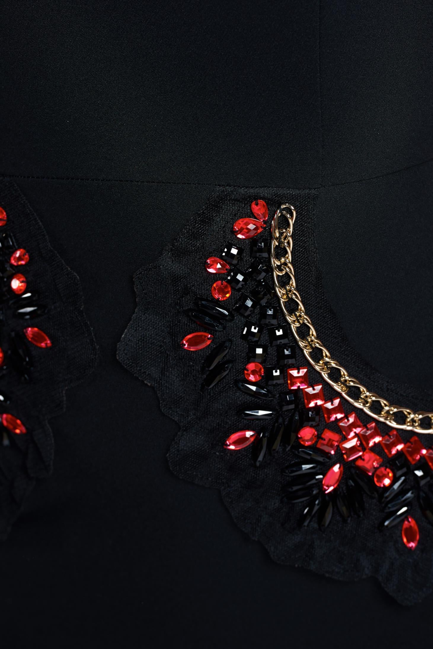 Elegant black dress accessorized with chain