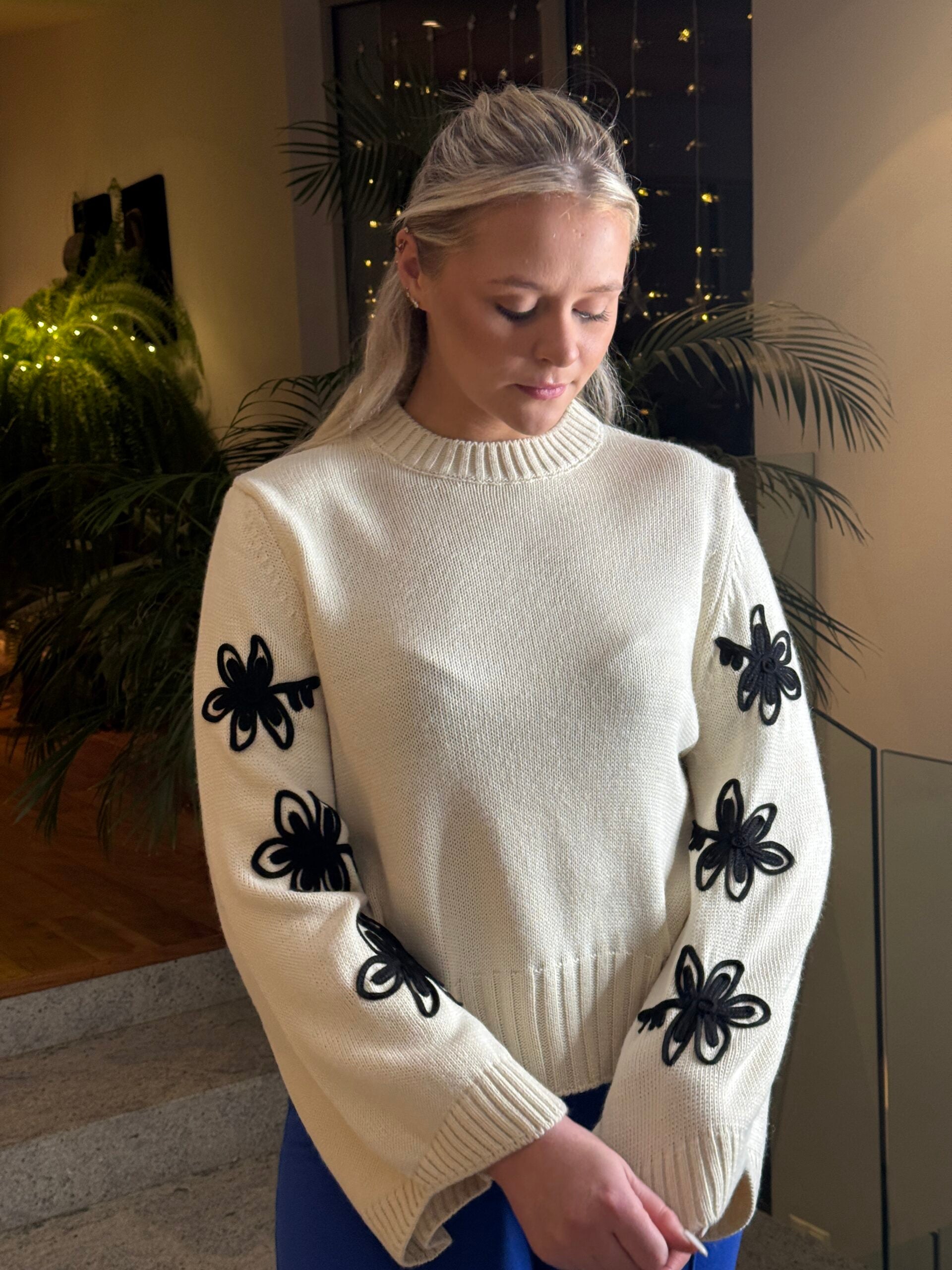 Elegant Ivory Sweater with Black Bow Accents