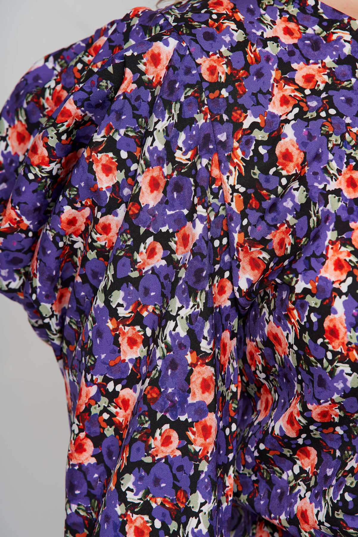 Purple Women`s Blouse With Floral Print Tented From Wrinkled Fabric High Shoulders.